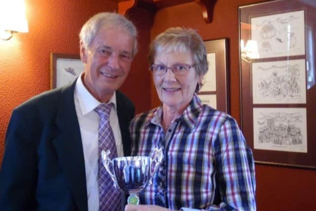 Hazel Clift is seen receiving her prize for the clubs Most Improved Player from secretary Tom Johnson.