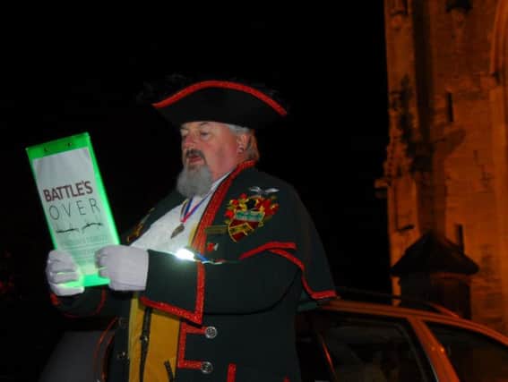 Sleaford Town Crier making his announcement in view of the war memorial in the Market Place.