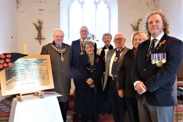 Pictured with the plaque are (from left) Mayor of Horncastle Coun Brian Burbidge, Julian Millington from the Horncastle & District Branch of the Royal British Legion, Jenny Oates, the Rev Cilla Smith, the Vice-Chairman of East Lindsey District Council David Andrews, Chairman of Asterby and Goulceby Parish Council Sandra Campbell-Wardman and John Norman of the British Legion. EMN-181211-112451001