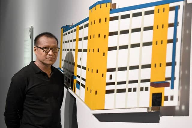 Festival of Glass at National Centre for Craft and Design. Artist Jeffrey Sarmiento with his work Tobacco Factory, waterjet cut and fused glass. EMN-181211-105014001