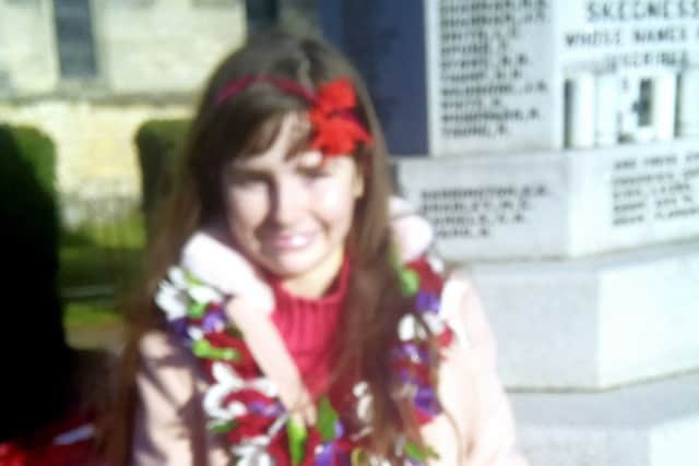 Penney Williams with the wreath she laid at the memorial in Skegness. ANL-181211-161234001