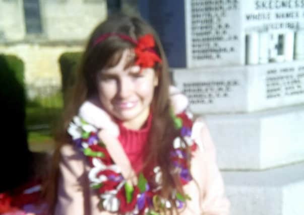 Penney Williams with the wreath she laid at the memorial in Skegness. ANL-181211-161234001