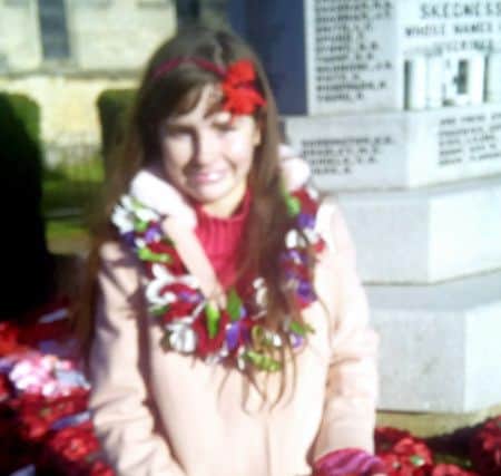 Penney Williams with the wreath she laid at the memorial in Skegness. ANL-181211-161234001