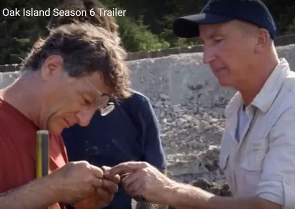 Gary Drayton hands his 'gold' find to Marty Lagina in the trailer to season six of Curse of Oak Island.