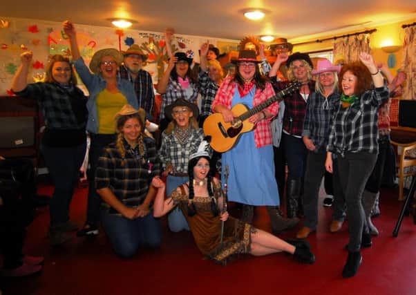 Residents and staff of Ashdene care home in Sleaford enjoy their cowboy day with country singer Lynn McFarland. EMN-181119-222542001