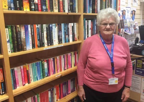 Volunteer Jean at St Barnabas Hospice bookshop in Louth prior to the flooding.