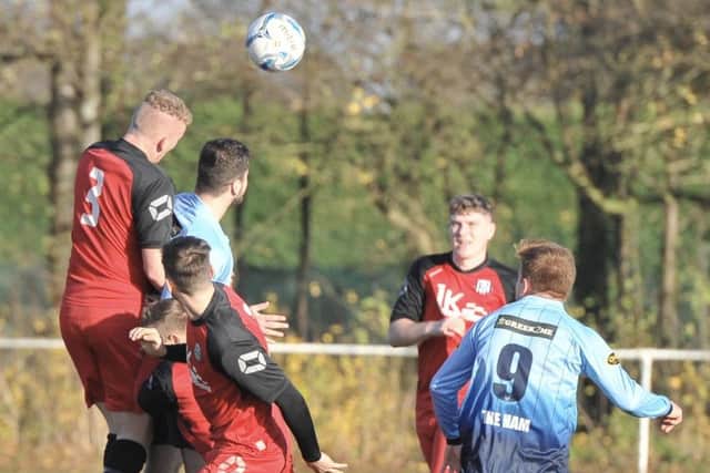 Brigg CIC skipper Joe Smithson (number 3) heads clear during the Lincolnshire League clash at Nettleham Picture: Nigel West EMN-181119-183531002