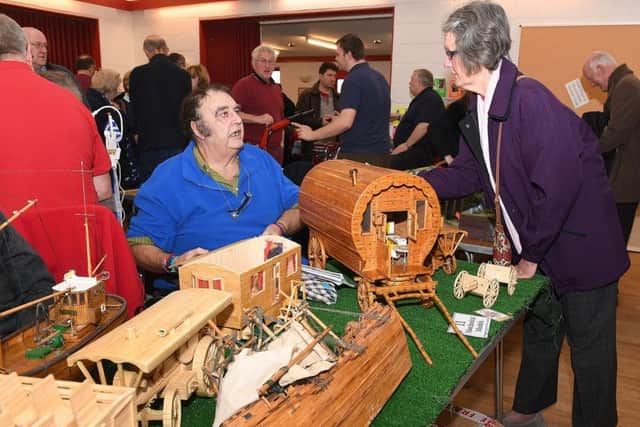 Charity model makers show in aid of Air Ambulance by Sleaford and District Model Railway Club. Keith Finton of Retford with his matchstick models, talking to Paula Sumner of Ruskington. EMN-181119-093404001