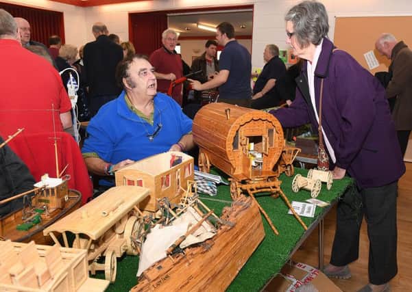 Charity model makers show in aid of Air Ambulance by Sleaford and District Model Railway Club. Keith Finton of Retford with his matchstick models, talking to Paula Sumner of Ruskington. EMN-181119-093404001