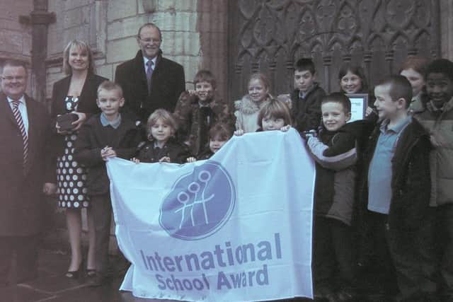 Pictured with some of the Park Primary Community schoolchildren outside the Boston Stump are (from left) John Rolfe, of the British Council, head teacher Carol Clare, and John Sandfield, of Lincolnshire County Council.