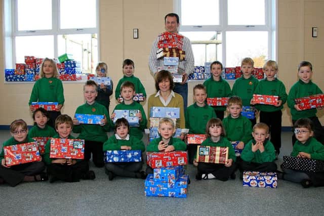 Steve Hill from Skegness Round Table, with teacher Belinda Clowsley and pupils from Great Steeping Primary School 10 years ago.