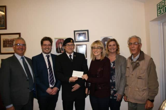 Pictured at the cheque presentation are (from left) Andrew Willoughby - Director of Music.  Elizabethan Singers. Josh Wilkinson - Musical Director, Alford Silver Band , John Johnson - Secretary, Alford Branch, Royal British Legion Kirsty Meik - Chairperson, Elizabethan Singers Joanne White - Treasurer, Elizabethan Singers Martin Briggs -  Chairman, Alford Silver Band ANL-181123-115148001