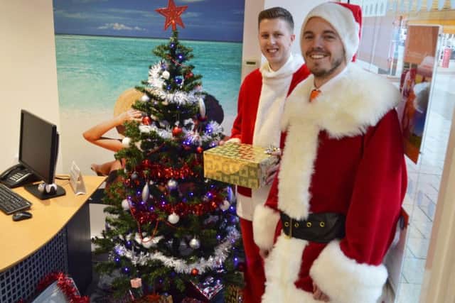 Aaron Hood and Dan OHagan from Lincolnshire Co-op travel. All 14 Lincolnshire Co-op travel branches are running the Santas Suitcase appeal for local food banks this festive season.