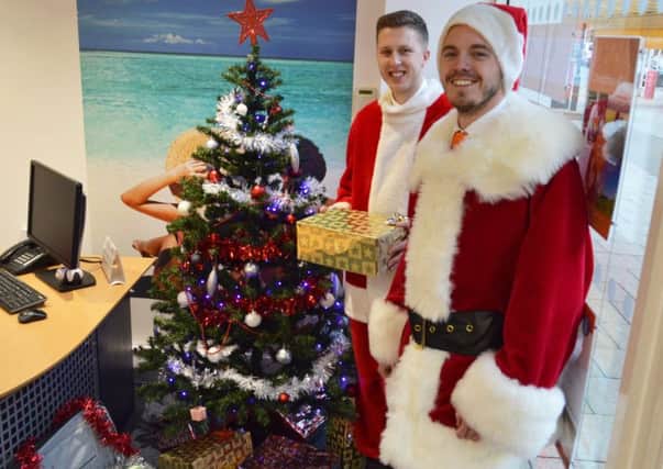 Aaron Hood and Dan OHagan from Lincolnshire Co-op travel. All 14 Lincolnshire Co-op travel branches are running the Santas Suitcase appeal for local food banks this festive season.