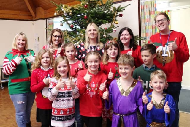 Head teacher Sarah Addison (back row, centre) celebrating with staff and pupils at Tetney Primary School before Christmas.