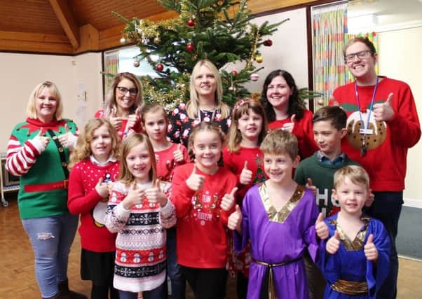 Head teacher Sarah Addison (back row, centre) celebrating with staff and pupils at Tetney Primary School before Christmas.