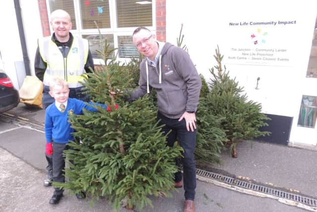 Kevin Skieth, chairman of Our Lady of Good Counsel School's PTA, presents the Christmas trees no longer needed to Rod Munro of Sleaford Community Larder. EMN-181217-172337001
