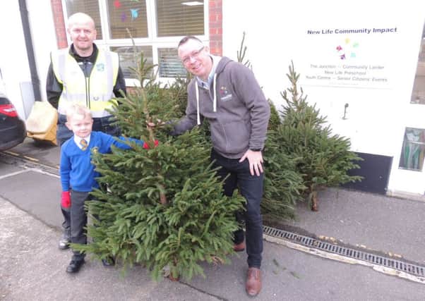 Kevin Skieth, chairman of Our Lady of Good Counsel School's PTA, presents the Christmas trees no longer needed to Rod Munro of Sleaford Community Larder. EMN-181217-172337001