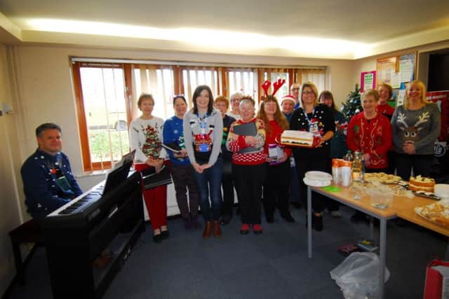 Staff at Heckington's Millview Medical Centre welcomed the University of the Third Age's Singing for Pleasure group who sang festive songs for waiting patients during their Christmas Jumper Day for charity. EMN-181217-173243001