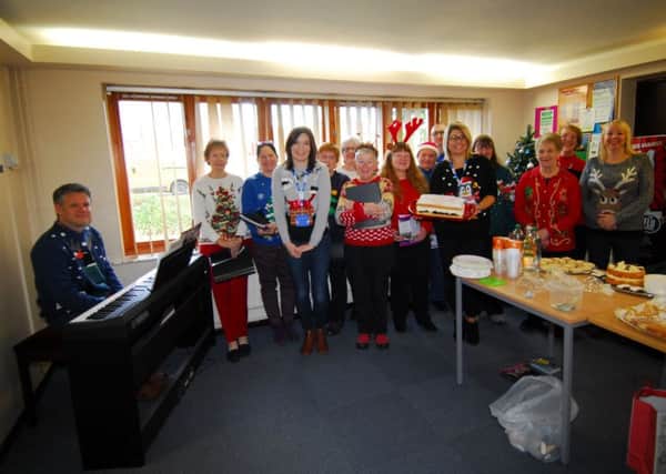 Staff at Heckington's Millview Medical Centre welcomed the University of the Third Age's Singing for Pleasure group who sang festive songs for waiting patients during their Christmas Jumper Day for charity. EMN-181217-173243001