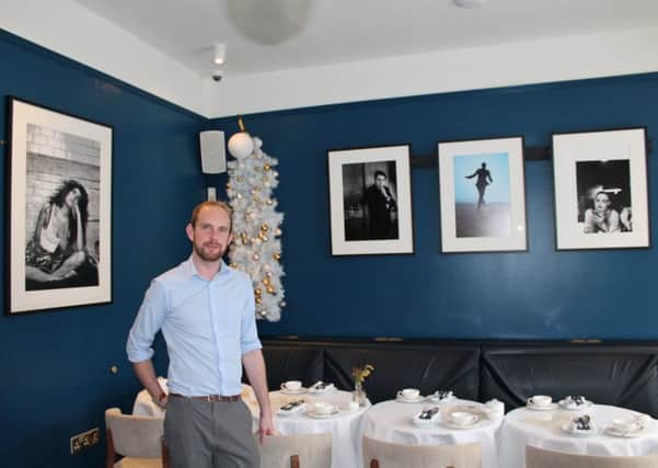 The Masons Arms manager, Alex Sweeney, is pictured above with some of the artwork.