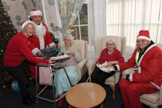 Sleaford All Knighters scooter club members dressed as santas, ride from Barge and Bottle to Roxholm Hall Care Centre. L-R Gill Freear - home manager, Paul Franks, Margaret Foreman - resident, Violet Crossland - resident, Roy Workman. EMN-181217-110355001