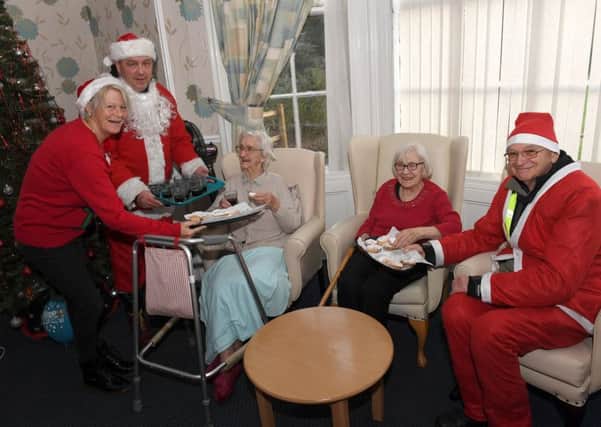 Sleaford All Knighters scooter club members dressed as santas, ride from Barge and Bottle to Roxholm Hall Care Centre. L-R Gill Freear - home manager, Paul Franks, Margaret Foreman - resident, Violet Crossland - resident, Roy Workman. EMN-181217-110355001