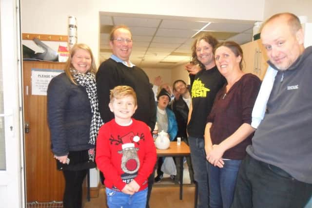 Little Oliver and mum Stacy (front left), alongside Richard Speed (behind Ollie), alongside ECHO volunteers.