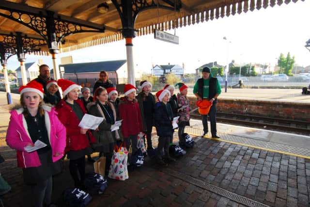 Heckington St Andrew's School choir performing Christmas songs on Sleaford station. EMN-181217-172326001