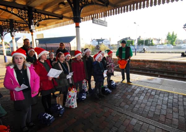 Heckington St Andrew's School choir performing Christmas songs on Sleaford station. EMN-181217-172326001