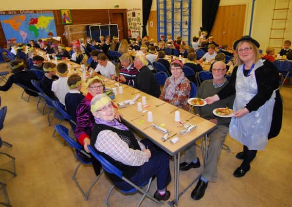Horbling Brown's School headteacher Sally Howley helping serve up Christmas lunches to pupils and invited villagers. EMN-181219-152622001