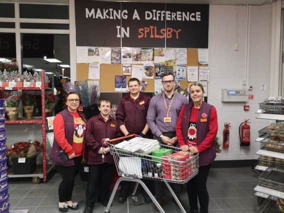 Staff at Sainsbury's in Spilsby preparing a trolley load of donations for the Spilsby Community Meal. ANL-181218-191715001