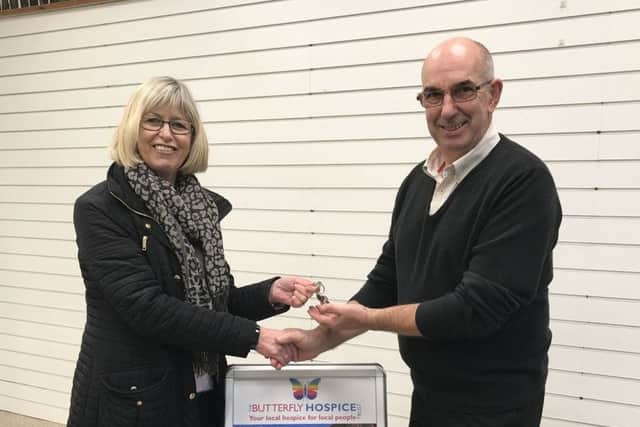Steve Doughty, from Butterfly Hospice, receives the keys from building owner Dianne Bartlett.