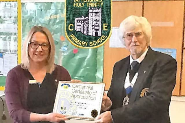Lion President Wally presented Holy Trinity CE School in Tattershall's head teacher Mrs Liley with a Centennial Certificate of Appreciation. EMN-181230-082204001