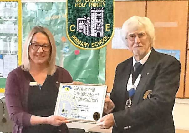 Lion President Wally presented Holy Trinity CE School in Tattershall's head teacher Mrs Liley with a Centennial Certificate of Appreciation. EMN-181230-082204001