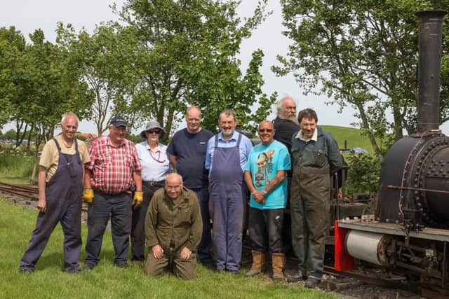 Some of the volunteers who have worked on Jurassic's restoration pose with her on the arrival of her first test train at South Loop on the LCLR; l-r Paul Walkinshaw, Chris Bates, Claire Smith, Tim Drury, Jim Smith, John Whaley, Richard Shepherd, Peter Balderston; (kneeling)Bob Laycock  and on the right, Jurassic. Photo Dave Enefer/LCLR. ANL-181227-095344001