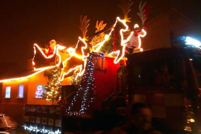 Santa aboard his sleigh flanked by firefighters in Sleaford. EMN-181227-104405001