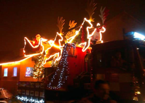 Santa aboard his sleigh flanked by firefighters in Sleaford. EMN-181227-104405001