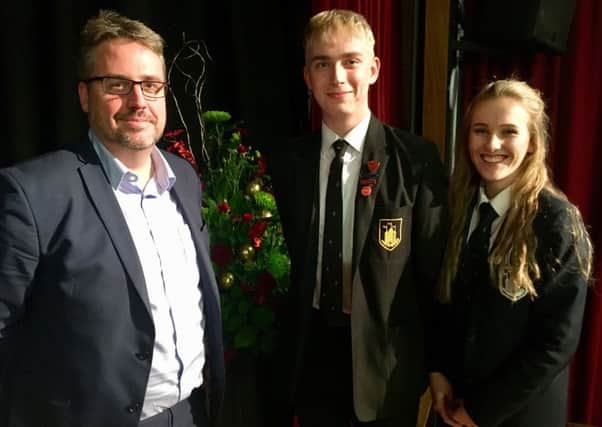Tim Shipman is pictured with Head Boy Tom Massey and Head Girl Joanna Ward.