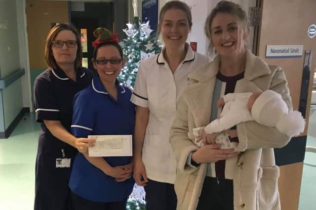 Early Years Foundation Stage teacher Beccy Sharpe and her son, Ruben, at Pilgrim Hospital in Boston to present a cheque to the neonatal team at the hospital. ANL-181228-084216001