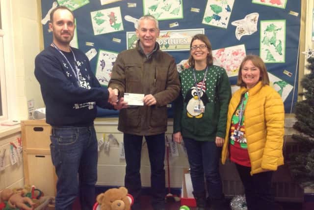 Headteacher Steve Bladon (left) pictured receiving a cheque from The Lions.