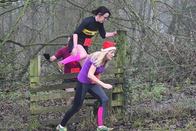 Runners negotiate a stile. Picture: Graham Stephenson EMN-181230-145703002