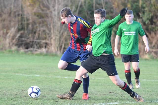 Railway Res (green) v Coningsby (red). Jenson Bark (red), Ashley Bond (green).