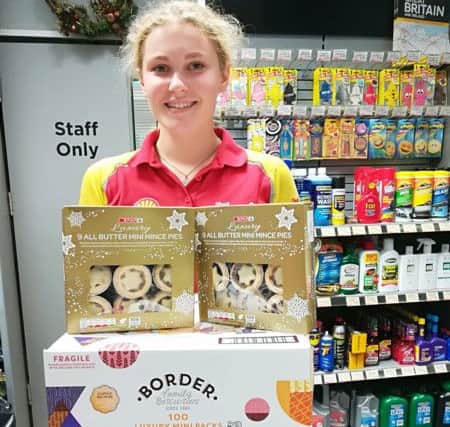 A member of staff at the Laurels Service Station with donations for the lunch EMN-181227-153809001