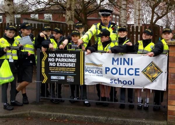 PCSO Nigel Wass with some of the mini police who are helping to get the safer parking message across