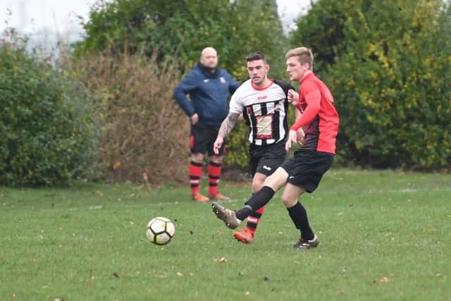 Kirton (red) v Spilsby (B/W). Michael Reeson (red), Ellis Cobb (B/W)