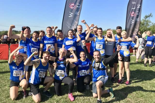 St Barnabas Hospice's Mike Pastor, pictured bottom right, with fundraisers during a Wolf Run event.