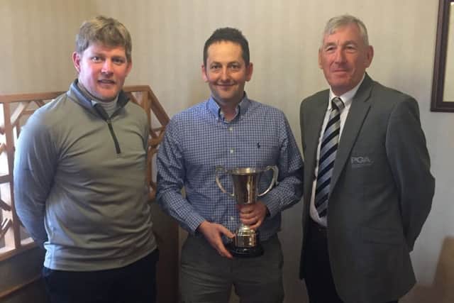 Paul Spence (centre) receives the county coach of the year award from Lincolnshire PGA secretary Alan Greives and captain Adam Keogh EMN-191001-110840002