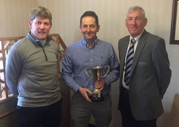 Paul Spence (centre) receives the county coach of the year award from Lincolnshire PGA secretary Alan Greives and captain Adam Keogh EMN-191001-110840002