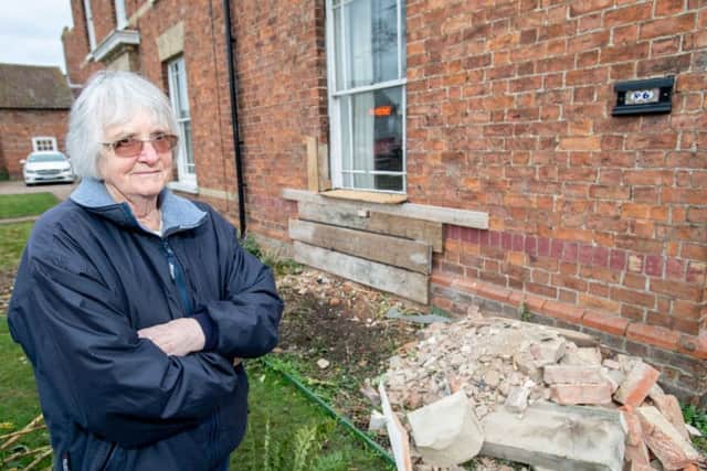 Lucky escape: Janet O'Regan in front of her boarded up house front. Picture: John Aron.